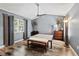 Neutral bedroom with modern ceiling fan, wood-look floors, and ample natural light from a bright window at 2306 63Rd W St # 40, Bradenton, FL 34209