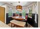 Cozy breakfast nook features a modern light fixture and three windows with patterned curtains at 2306 63Rd W St # 40, Bradenton, FL 34209
