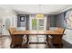 Elegant dining room features wood floors, stylish light fixture, and French doors to the backyard at 2306 63Rd W St # 40, Bradenton, FL 34209