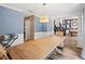 Dining room with light blue walls, white trim, and wood-look floors, open to the living room and staircase at 2306 63Rd W St # 40, Bradenton, FL 34209