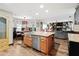 Open-concept kitchen with large island, stainless steel appliances, and view of the living area at 2306 63Rd W St # 40, Bradenton, FL 34209