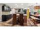 Modern kitchen with a granite island, stainless steel appliances and dark cabinets adjacent to the breakfast nook at 2306 63Rd W St # 40, Bradenton, FL 34209