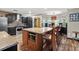 Kitchen showcases island with seating, stainless steel appliances, granite counters, and stylish light fixture at 2306 63Rd W St # 40, Bradenton, FL 34209