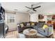 Spacious living room features a comfortable sectional sofa, wood-look floors, and modern ceiling fan at 2306 63Rd W St # 40, Bradenton, FL 34209