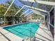 Screened-in pool with clear blue water and surrounding palm trees at 2306 63Rd W St # 40, Bradenton, FL 34209