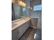Modern bathroom featuring dual sinks, vanity with white cabinets and a glass-enclosed shower at 24779 Buckingham Way, Port Charlotte, FL 33980