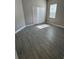 Cozy bedroom with wood-look flooring and a closet, illuminated by natural light from a window at 24779 Buckingham Way, Port Charlotte, FL 33980