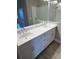 Bathroom featuring double sink vanity with countertop space and tiled flooring at 24831 Buckingham Way, Port Charlotte, FL 33980