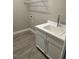 Practical laundry area with a sink, white cabinets, and tile flooring at 24831 Buckingham Way, Port Charlotte, FL 33980