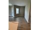Living room with wood-look tile, a front door entrance, and plenty of natural light at 24831 Buckingham Way, Port Charlotte, FL 33980