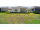Well-maintained backyard with green lawn and view of house at 2625 Star Apple Way, Sarasota, FL 34240