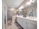 Bright bathroom features double vanity with modern fixtures, and a glass-enclosed shower at 2625 Star Apple Way, Sarasota, FL 34240