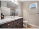 Stylish bathroom featuring wood cabinets, mirror, sink and window at 2625 Star Apple Way, Sarasota, FL 34240