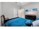 Bedroom featuring blue comforter, TV, light gray walls, and white doors at 2625 Star Apple Way, Sarasota, FL 34240