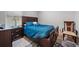 Cozy bedroom features a dark wood frame bed, patterned rug, and neutral wall colors at 2625 Star Apple Way, Sarasota, FL 34240