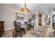 This dining room features a glass-top table, ornate chandelier, and decorative rugs at 2625 Star Apple Way, Sarasota, FL 34240