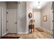 Inviting entryway with wood floors, neutral walls, and a decorative mirror and table at 2625 Star Apple Way, Sarasota, FL 34240