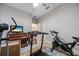 Exercise room with treadmill, cycle bike, TV, and neutral wall color at 2625 Star Apple Way, Sarasota, FL 34240