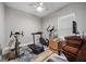 Bright exercise room featuring exercise bike, treadmill, fan, and gray walls at 2625 Star Apple Way, Sarasota, FL 34240