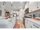 Modern kitchen featuring white cabinetry, stainless steel appliances, and a stylish backsplash at 2625 Star Apple Way, Sarasota, FL 34240