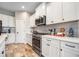 Well-lit kitchen features white cabinetry, stainless steel appliances, and stylish backsplash at 2625 Star Apple Way, Sarasota, FL 34240
