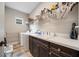 Functional laundry room with sink, white cabinets, and washing machine at 2625 Star Apple Way, Sarasota, FL 34240