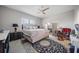 Spacious main bedroom with plush rug, neutral tones, and a ceiling fan for added comfort at 2625 Star Apple Way, Sarasota, FL 34240