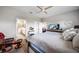 Comfortable main bedroom with a large bed, ceiling fan, and ensuite bathroom access at 2625 Star Apple Way, Sarasota, FL 34240