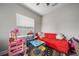 Colorful play room with red sofa and toys at 2625 Star Apple Way, Sarasota, FL 34240