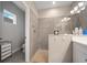This walk-in shower features neutral tile, glass enclosure, and a convenient toiletry shelf at 2625 Star Apple Way, Sarasota, FL 34240