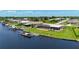 Aerial view of the property including canal frontage, a boat lift, and a relaxing screened-in lanai at 264 E Tarpon Nw Blvd, Port Charlotte, FL 33952