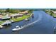 Aerial view of the property on the canal, showing the boat lift and seawall on a sunny day at 264 E Tarpon Nw Blvd, Port Charlotte, FL 33952