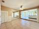 Open living space featuring neutral tile floors, mirrored closet and a ceiling fan at 264 E Tarpon Nw Blvd, Port Charlotte, FL 33952