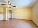 An empty bedroom with laminate flooring, ceiling fan, and closet at 264 E Tarpon Nw Blvd, Port Charlotte, FL 33952