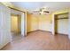 Bedroom with laminate floors, closet with folding doors, and ceiling fan at 264 E Tarpon Nw Blvd, Port Charlotte, FL 33952