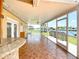 Large covered patio overlooking the canal with brick pavers, ceiling fan and bar area at 264 E Tarpon Nw Blvd, Port Charlotte, FL 33952