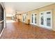 Spacious brick-paved lanai with ample room for entertaining and multiple access points to the main house at 264 E Tarpon Nw Blvd, Port Charlotte, FL 33952
