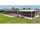 Back of the house features a large lanai with brick floors, offering ample outdoor living and entertainment space at 264 E Tarpon Nw Blvd, Port Charlotte, FL 33952