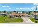 Inviting single-Gathering home showcasing a lush lawn, mature landscaping, and well-maintained exterior at 264 E Tarpon Nw Blvd, Port Charlotte, FL 33952