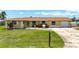 Charming one-story home with lush front yard, updated roof, and a welcoming exterior at 264 E Tarpon Nw Blvd, Port Charlotte, FL 33952