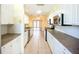 A kitchen with white cabinets, stainless steel appliances, and a view into the next room at 264 E Tarpon Nw Blvd, Port Charlotte, FL 33952