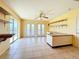 Bright kitchenette with a ceiling fan, tile flooring, and open shelving at 264 E Tarpon Nw Blvd, Port Charlotte, FL 33952