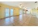 Expansive living area with tile flooring, multiple ceiling fans, and access to an outdoor patio at 264 E Tarpon Nw Blvd, Port Charlotte, FL 33952