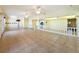 Open living area with tile flooring, multiple ceiling fans, and access to other rooms at 264 E Tarpon Nw Blvd, Port Charlotte, FL 33952