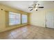 Bright living room with tile flooring, large windows, and a glass door at 264 E Tarpon Nw Blvd, Port Charlotte, FL 33952
