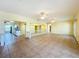 Open living room boasts tile floors and a seamless flow to the kitchen area at 264 E Tarpon Nw Blvd, Port Charlotte, FL 33952