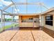 Covered outdoor kitchen on a brick patio with stainless steel refrigerator and view of the water at 264 E Tarpon Nw Blvd, Port Charlotte, FL 33952