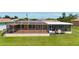 A spacious screened patio featuring a textured floor provides an enjoyable outdoor space for relaxing and entertaining at 264 E Tarpon Nw Blvd, Port Charlotte, FL 33952