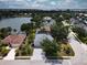 Aerial view of home featuring a private pool, screened enclosure, and manicured landscaping near the waterfront at 318 39Th Ne St, Bradenton, FL 34208