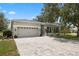 Charming single-story home with a paved driveway, attached garage, and well-maintained landscaping at 318 39Th Ne St, Bradenton, FL 34208